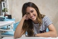 Smiling girl sitting on a terrace