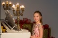 Portrait of Beautiful Smiling Girl Sitting at Piano Looking at Camera. Royalty Free Stock Photo