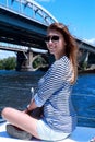 Smiling girl sitting on yacht deck Royalty Free Stock Photo