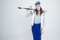 Smiling girl skier in a hat and mask for skiing. A young woman in clothes for skiing and outdoor activities. Royalty Free Stock Photo