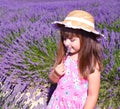 Smiling girl sniffing flowers in a lavender field Royalty Free Stock Photo