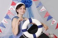 Smiling girl with steering wheel and marine decor Royalty Free Stock Photo