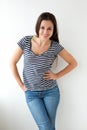 Smiling girl striped shirt against white wall