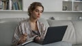 Smiling girl studying home watching online university class in pajamas closeup. Royalty Free Stock Photo