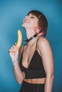 smiling girl in stylish crop top holding banana