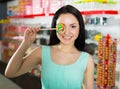 Smiling girl sucking lollypop in store