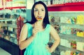Smiling girl sucking lollypop in store Royalty Free Stock Photo