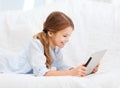 Smiling girl with tablet computer at home Royalty Free Stock Photo