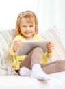 Smiling girl with tablet pc computer at home Royalty Free Stock Photo