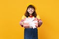 Smiling girl teenager in french beret, denim sundress holding red striped present box with gift ribbon isolated on Royalty Free Stock Photo