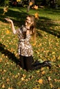 Smiling girl throwing leaves Royalty Free Stock Photo