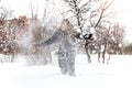 Smiling girl throwing snow in the air at sunny winter day Royalty Free Stock Photo