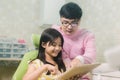 A smiling girl with thumb raised having teeth examination at dental clinic. People, medicine, stomatology and health care concept