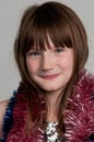 Smiling girl with tinsel, studio shot Royalty Free Stock Photo