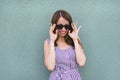 Smiling girl in trendy dress and sunglasses Royalty Free Stock Photo