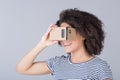 Smiling girl using virtual reality device cardboard Royalty Free Stock Photo