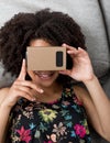 Smiling girl using virtual reality device cardboard vr Royalty Free Stock Photo