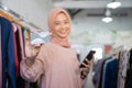 smiling a girl in veil holding a credit card and a handphone Royalty Free Stock Photo