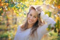 Smiling girl among warm autumn colors