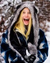 Smiling girl in warm clothing with snowball. Beautiful young woman playing with snow in winter park. Royalty Free Stock Photo