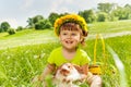 Smiling girl wearing flowers circlet and rabbit