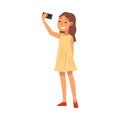 Smiling Girl Wearing Yellow Dress Taking Selfie Photo, Cute Child Character Photographing Herself with Smartphone Royalty Free Stock Photo