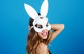 Smiling girl in white bunny ears. Easter woman in carnival rabbit mask. Spring holiday.