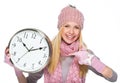 Smiling girl in winter clothes pointing on clock Royalty Free Stock Photo