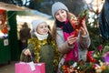 Smiling girl with woman are buying Christmas ornamentals