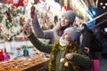 Smiling girl with woman are buying Christmas ornamentals