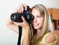 Smiling girl working with photocamera Royalty Free Stock Photo