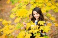 Smiling girl in yellow maple leaves, autumn Royalty Free Stock Photo