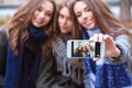 Smiling girlfriends making selfie photo Royalty Free Stock Photo