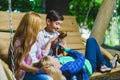 Smiling girls and boy having fun at playground. Children playing outdoors in summer. Teenagers on a swing. Royalty Free Stock Photo