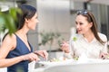 Smiling girls eating salad at desk