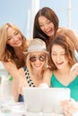 Smiling girls looking at tablet pc in cafe Royalty Free Stock Photo