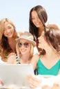 Smiling girls looking at tablet pc in cafe Royalty Free Stock Photo