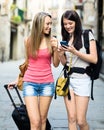 Smiling girls using smartphone navigating system Royalty Free Stock Photo