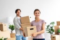 Smiling glad millennial caucasian family packing stuff, carry cardboard boxes in room interior, enjoy moving Royalty Free Stock Photo