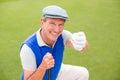 Smiling golfer kneeling on the putting green Royalty Free Stock Photo