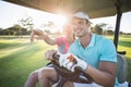 Smiling golfer woman pointing by man Royalty Free Stock Photo