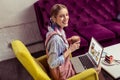 Smiling good-looking lady with scarf in her hair carrying cocoa with marshmallow Royalty Free Stock Photo