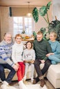 Smiling gorgeous family sitting on the couch with a laptop Royalty Free Stock Photo