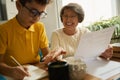 Smiling governess helping child to study during quarantine Royalty Free Stock Photo