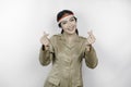 Smiling government worker woman gesturing love sign with her fingers isolated by white background. PNS wearing khaki uniform.