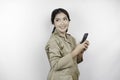 Smiling government worker woman holding her smartphone. PNS wearing khaki uniform