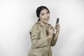 Smiling government worker woman holding her smartphone. PNS wearing khaki uniform
