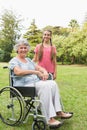 Smiling granddaughter with grandmother in her wheelchair