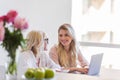 Smiling granddaughter and grandmother using laptop computer Royalty Free Stock Photo