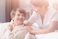 Smiling granddaughter hugging happy grandmother during family meeting